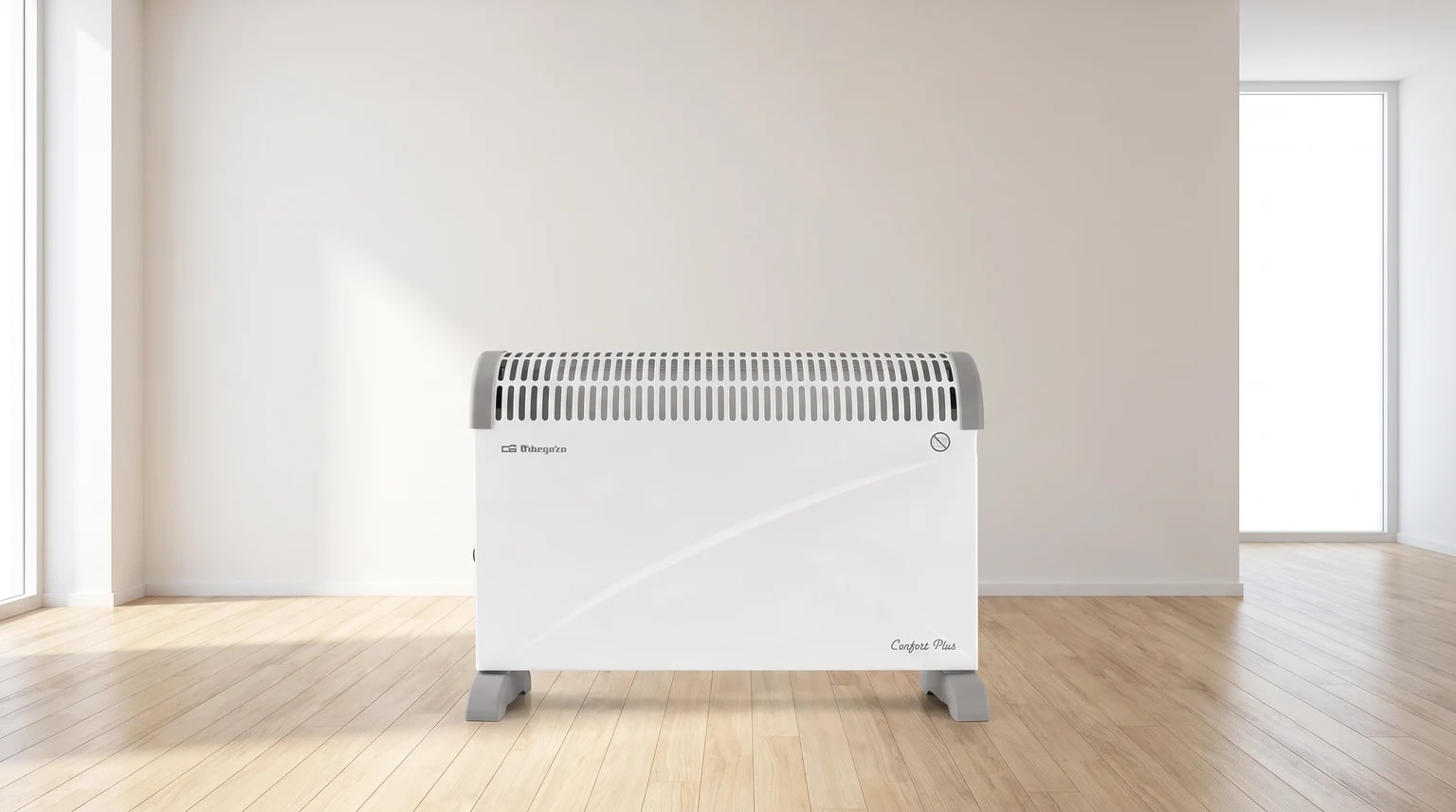 Convector elétrico Orbegozo branco e cinzento sobre um chão de madeira, numa sala ampla e luminosa.
