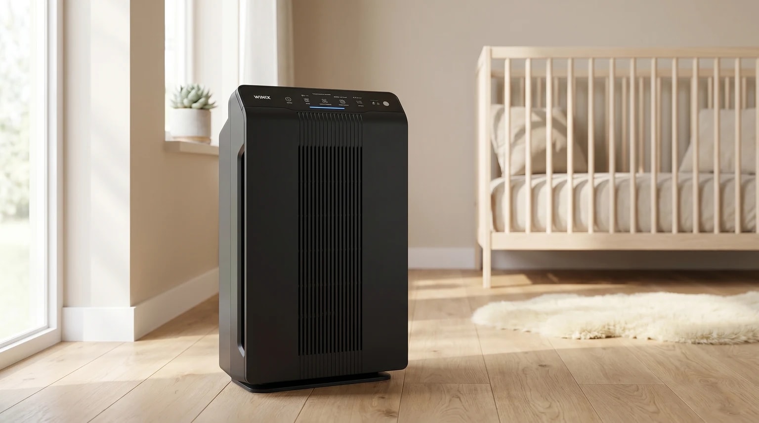 A black air purifier stands on a wooden floor in a sunlit nursery, with a light-coloured wooden cot and a fluffy rug in the background.